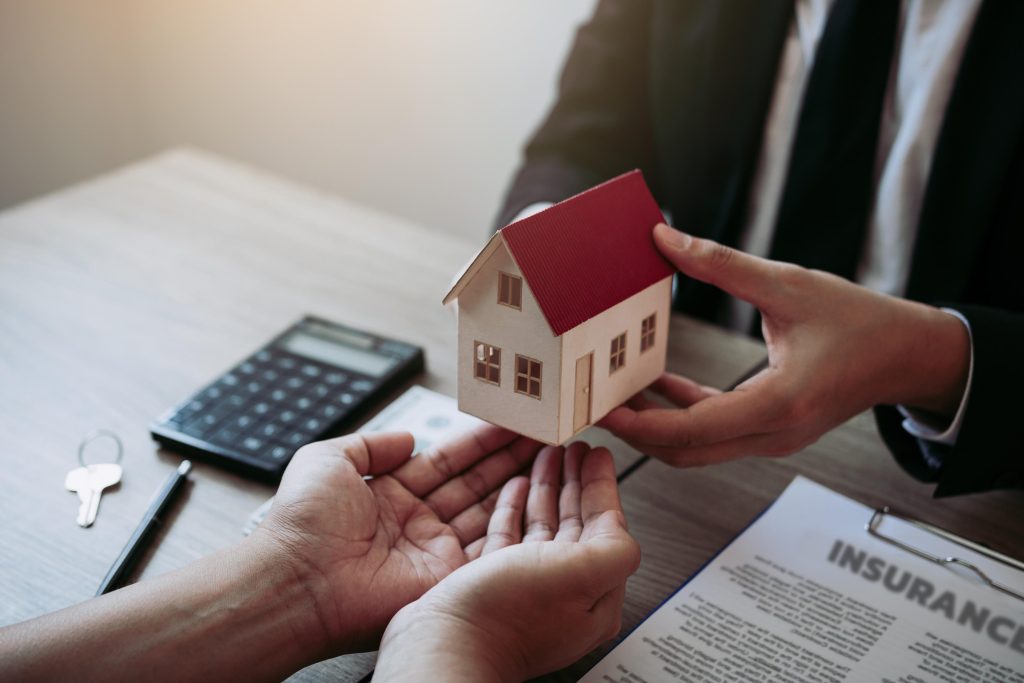Real estate agent congratulations to new buyer by giving house m