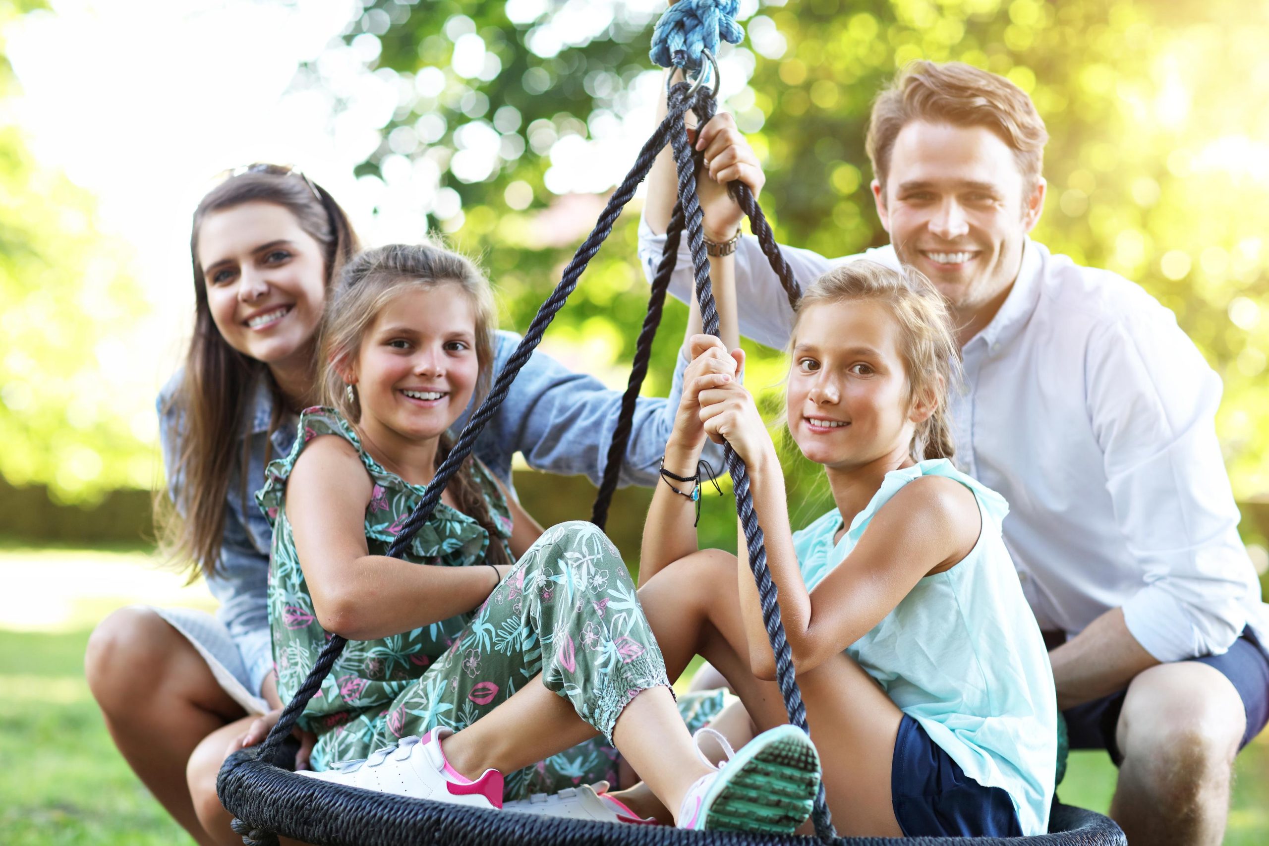 Joyful family having fun on playground