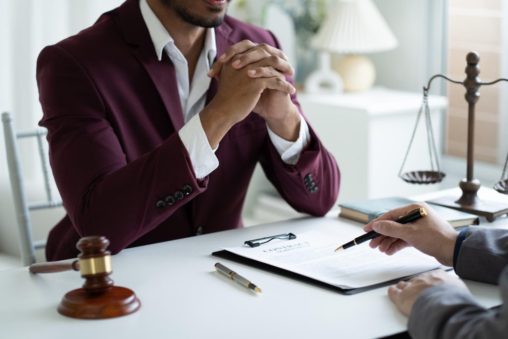 Young professional lawyer consulting with his client, listening