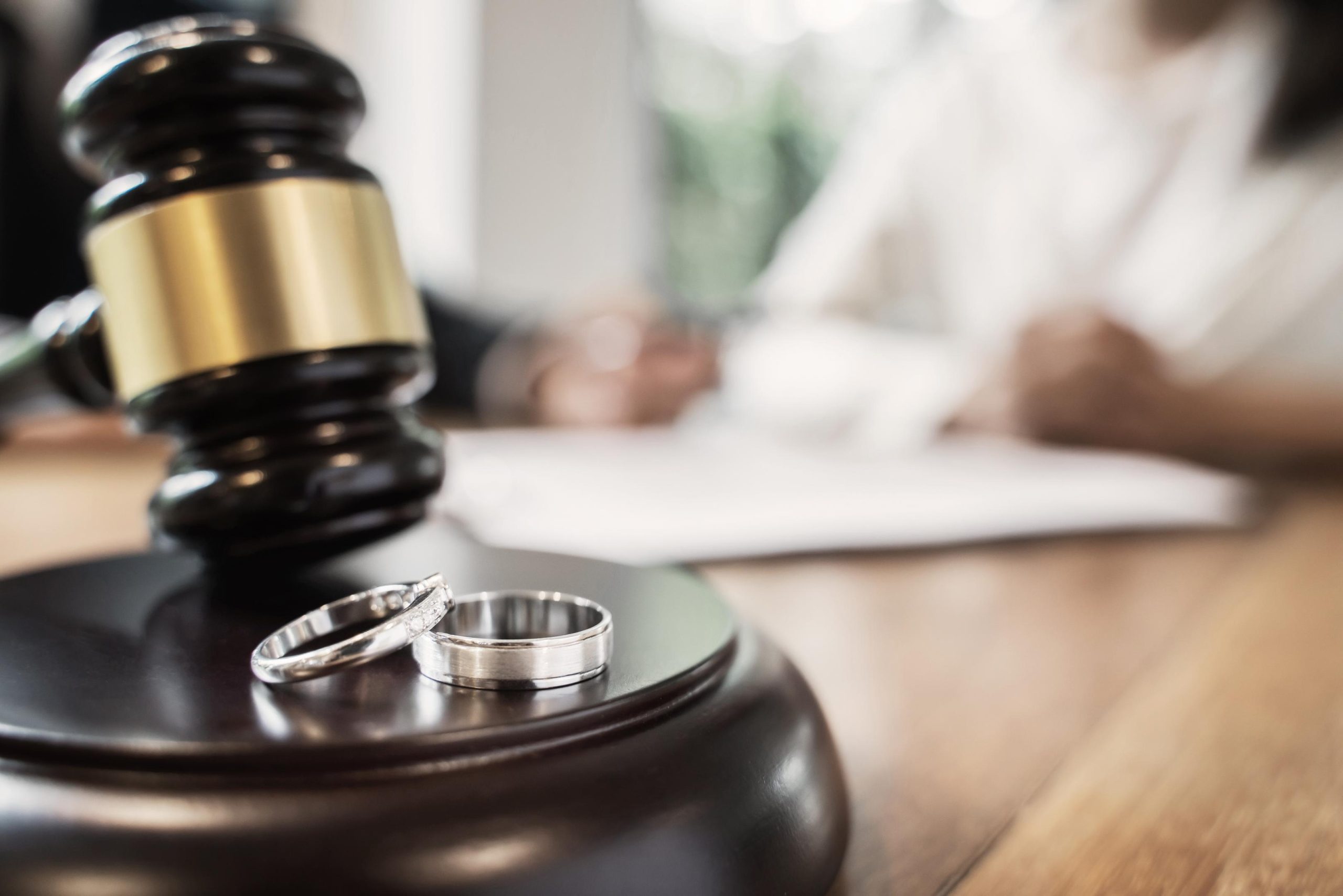 Divorce concept with gavel and wedding rings