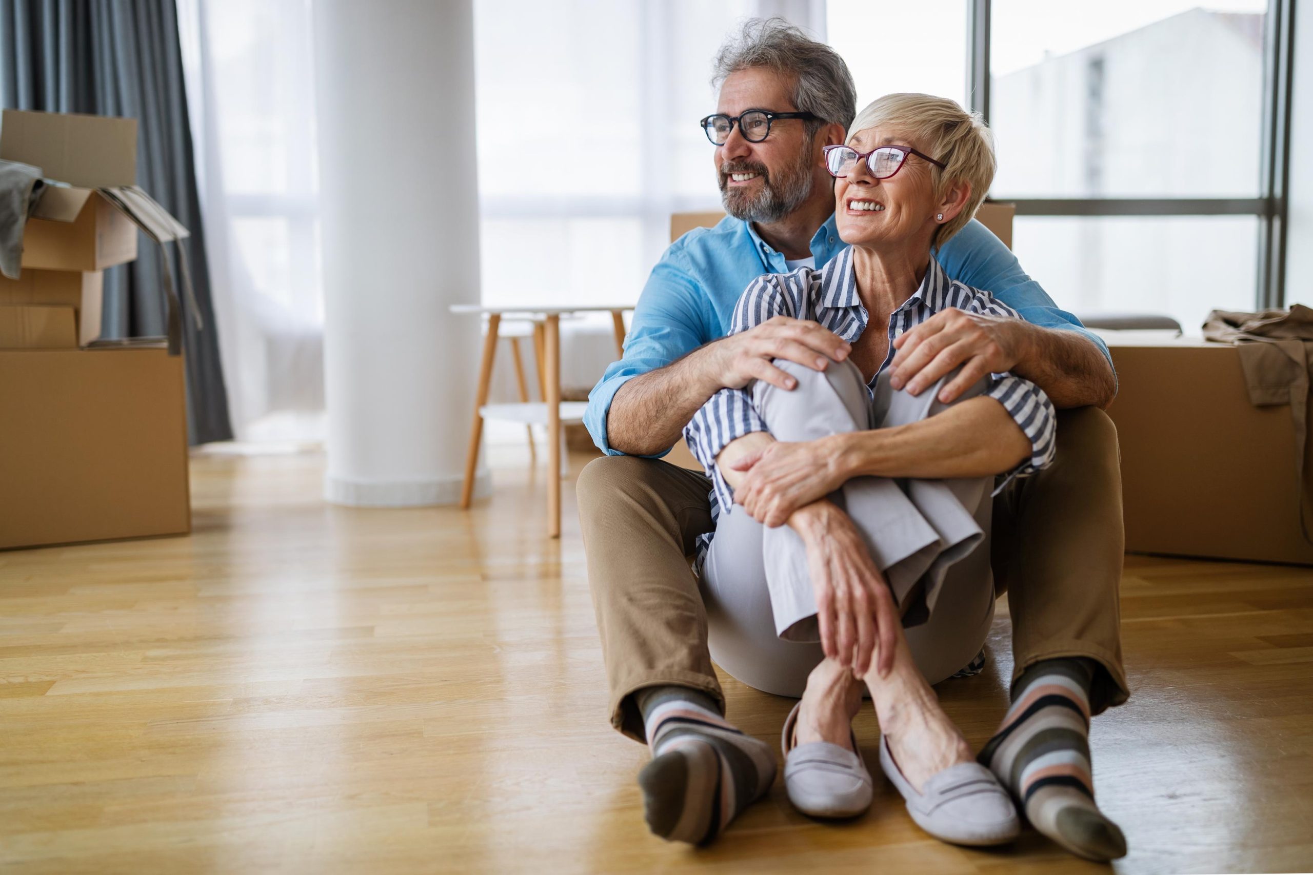 Portrait of happy senior couple in love moving in new home