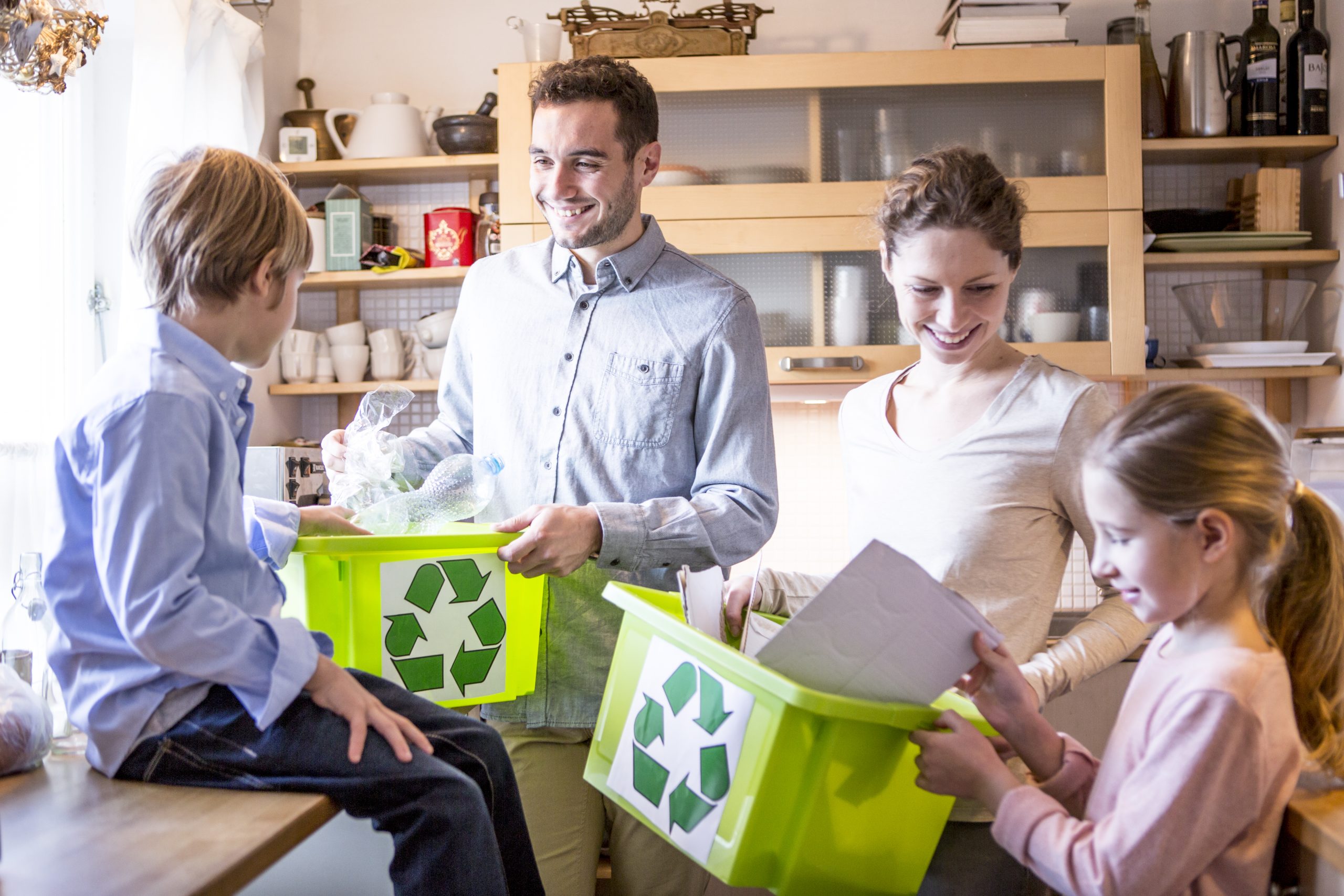 family and kids sorting trash in boxes
