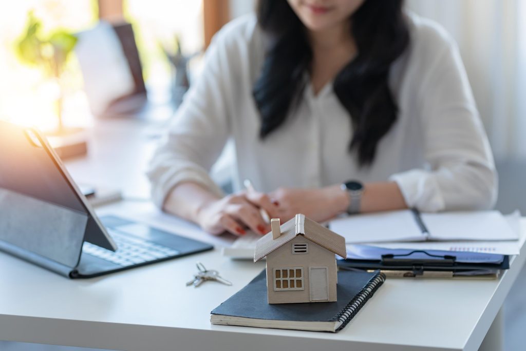 Businesswoman doing finances and calculate about cost to real es
