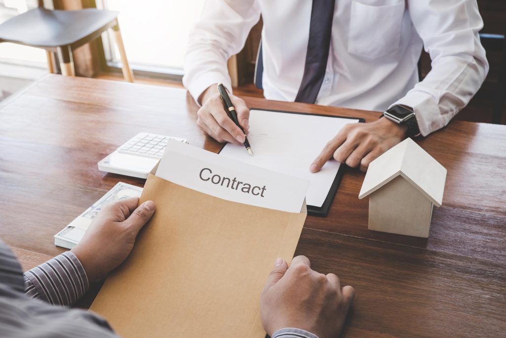 Business Signing a Contract Buy - sell house, Man sign a home in
