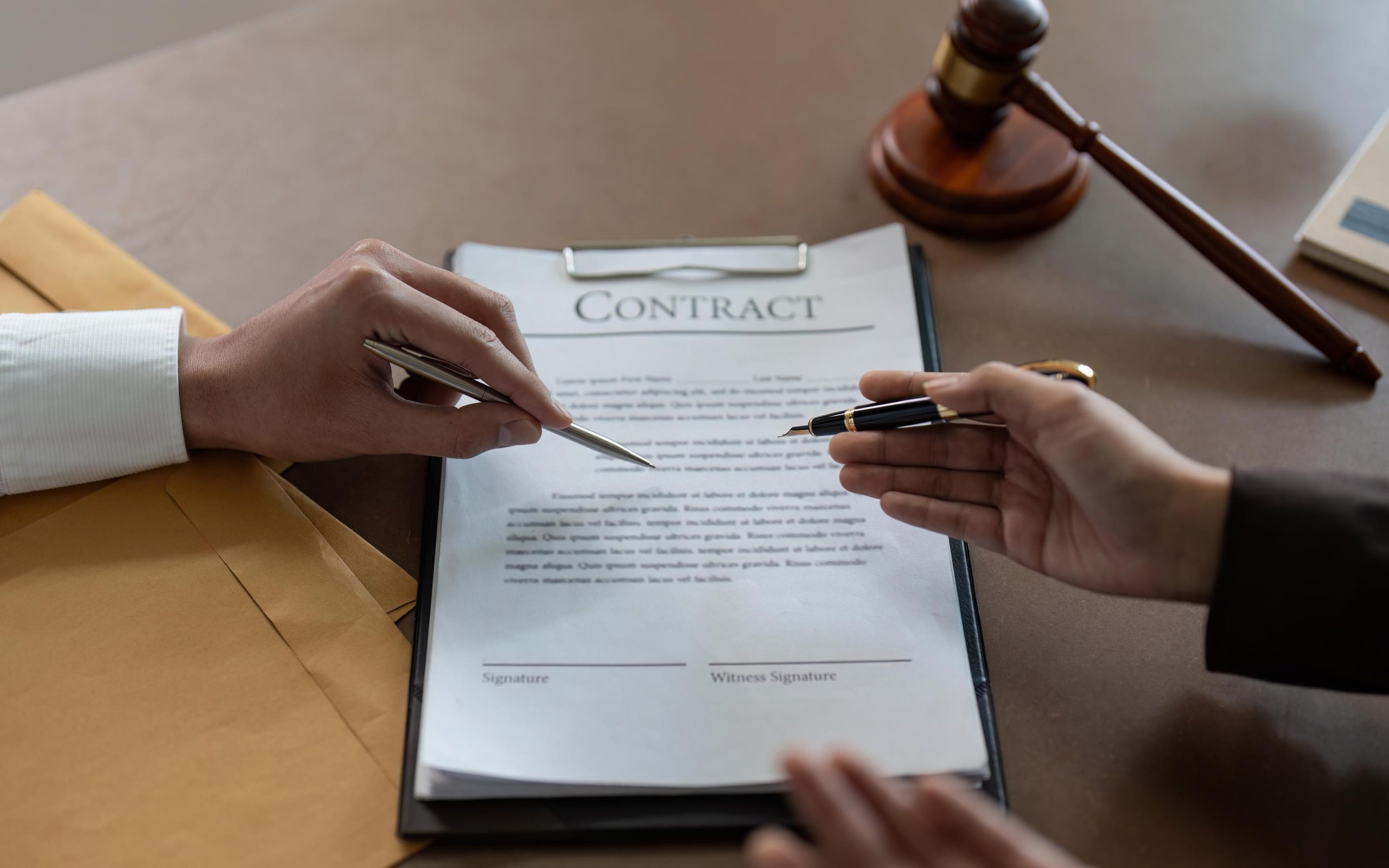 Contract Negotiation with Pen in Office Setting